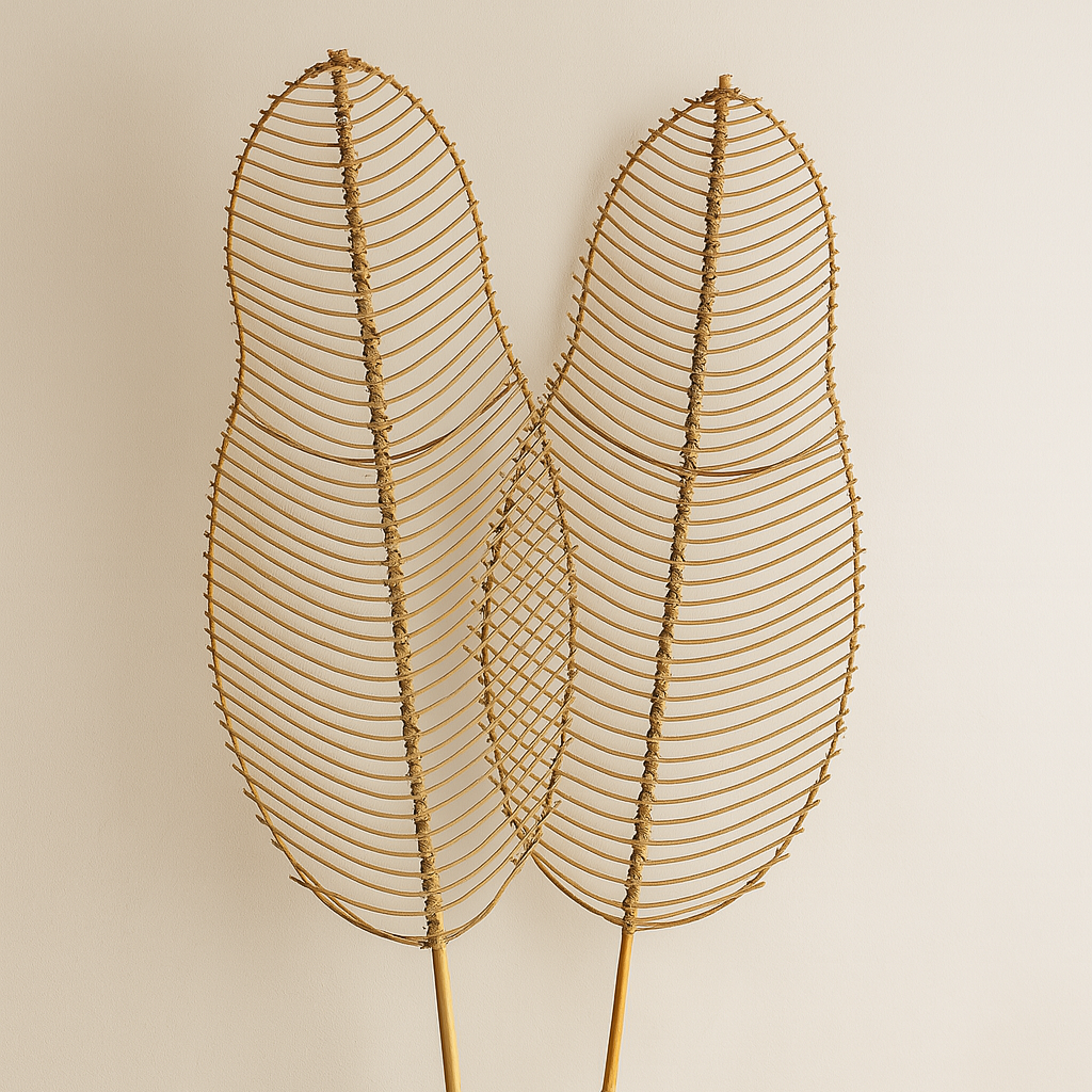 Decorative wire leaf sculpture in a white vase against a beige background